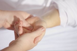 Massaging a child's hand using acupressure